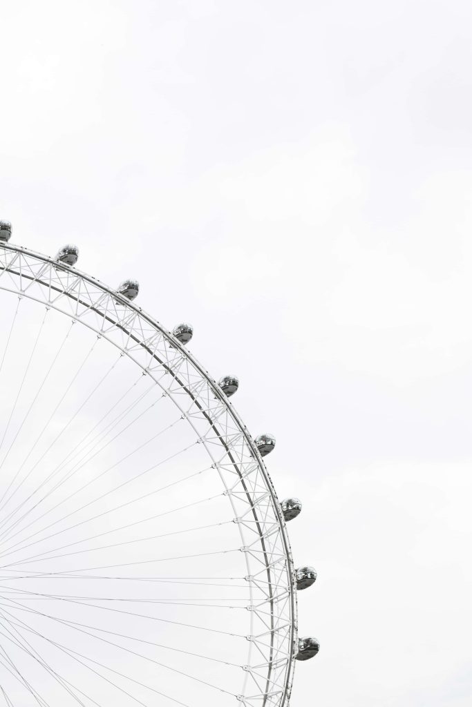 Minimalist London Eye against white sky steel structure with passenger capsules modern wallpaper
