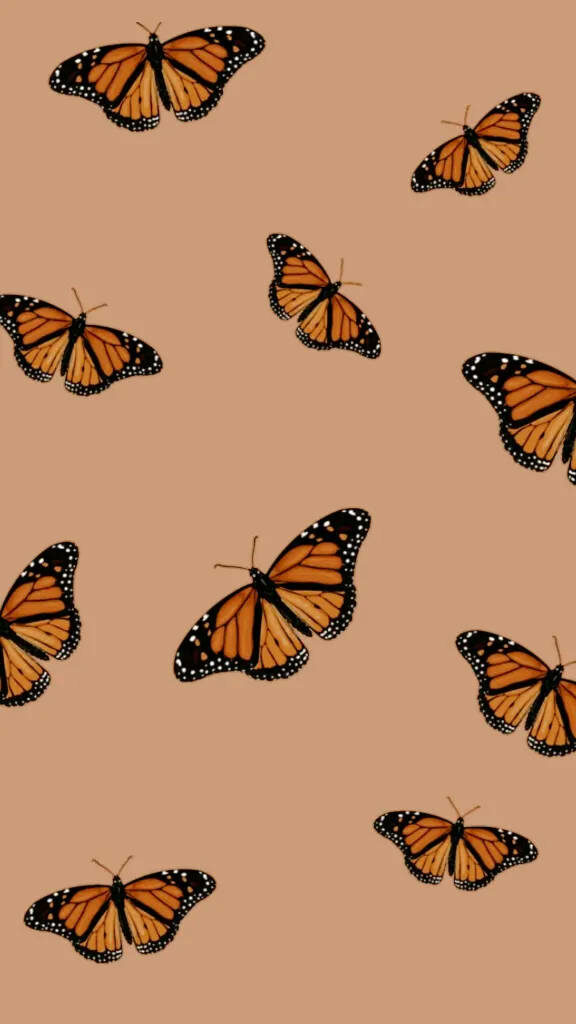 Vibrant Monarch Butterflies Wallpaper on Warm Beige - Minimalist Aesthetic