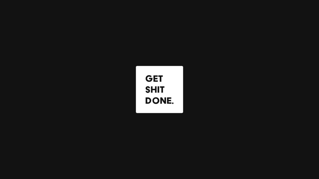 Minimalist wallpaper with bold black text Get Shit Done on white square and dark background