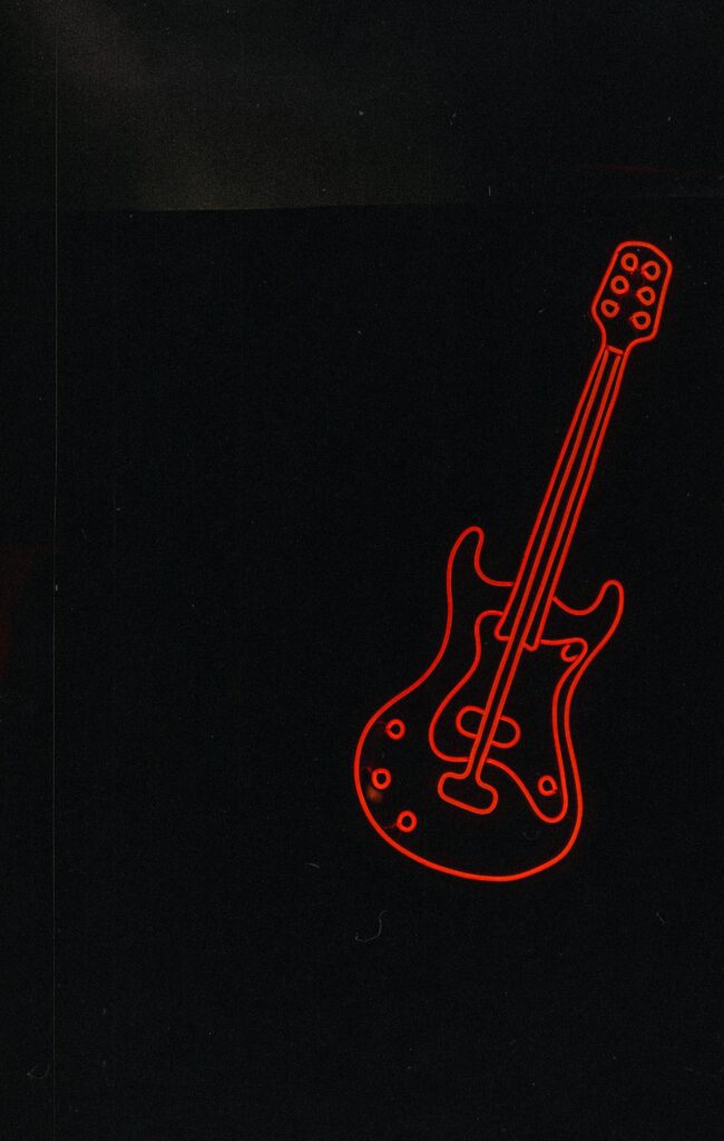 “Neon Red Electric Guitar Wallpaper on Dark Background”