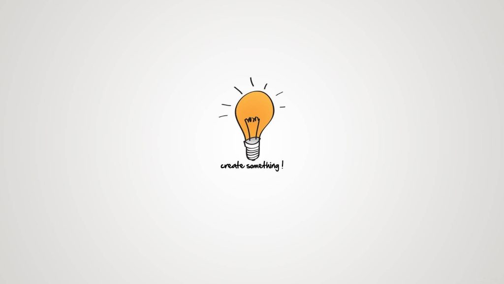 Minimalist 2D glowing orange lightbulb with inspirational create something quote on white background Wallpaper