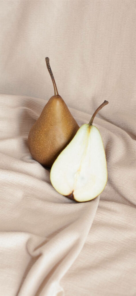 Minimalist Ripe Pear Wallpaper on Soft Beige Fabric Background