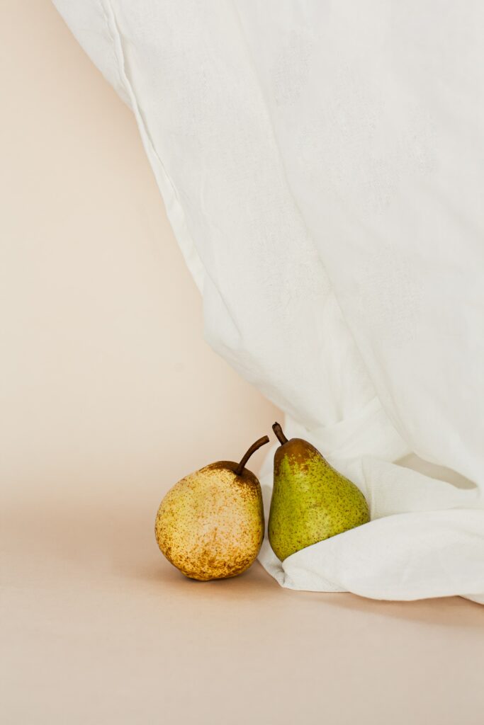 Minimalist Pear Wallpaper: Green & Yellow Fruits on Neutral Background