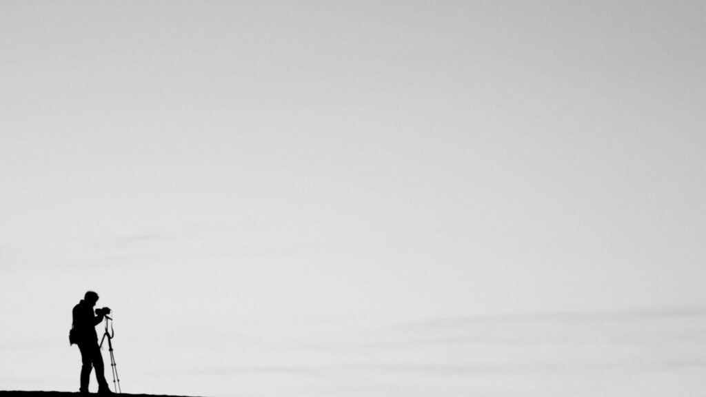 Minimalist 4K Photographer Silhouette Wallpaper - Serene Gray Background