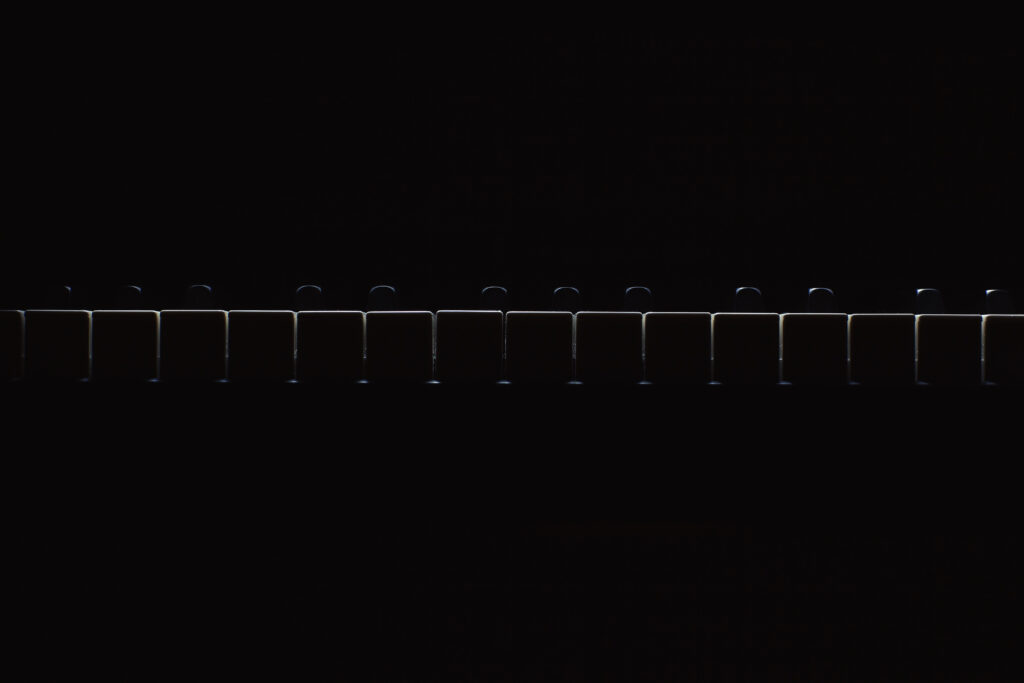 Minimalist Piano Keys Wallpaper on Dark Background - Modern Contrast