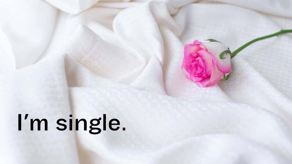 Minimalist wallpaper with pink white rose on white sheets and clean Im single text background