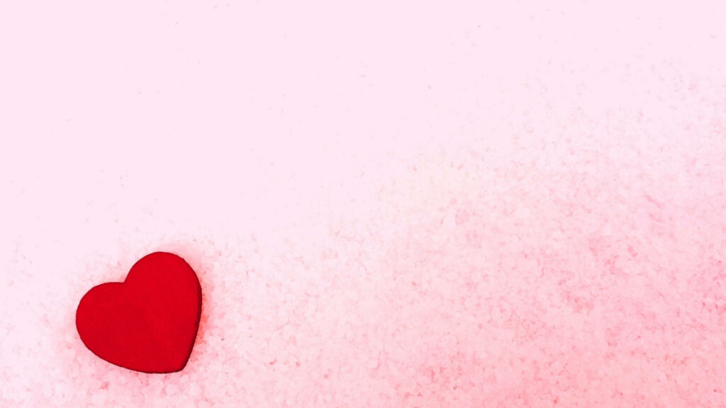Minimalist Red Heart Wallpaper on Soft Pink Textured Background