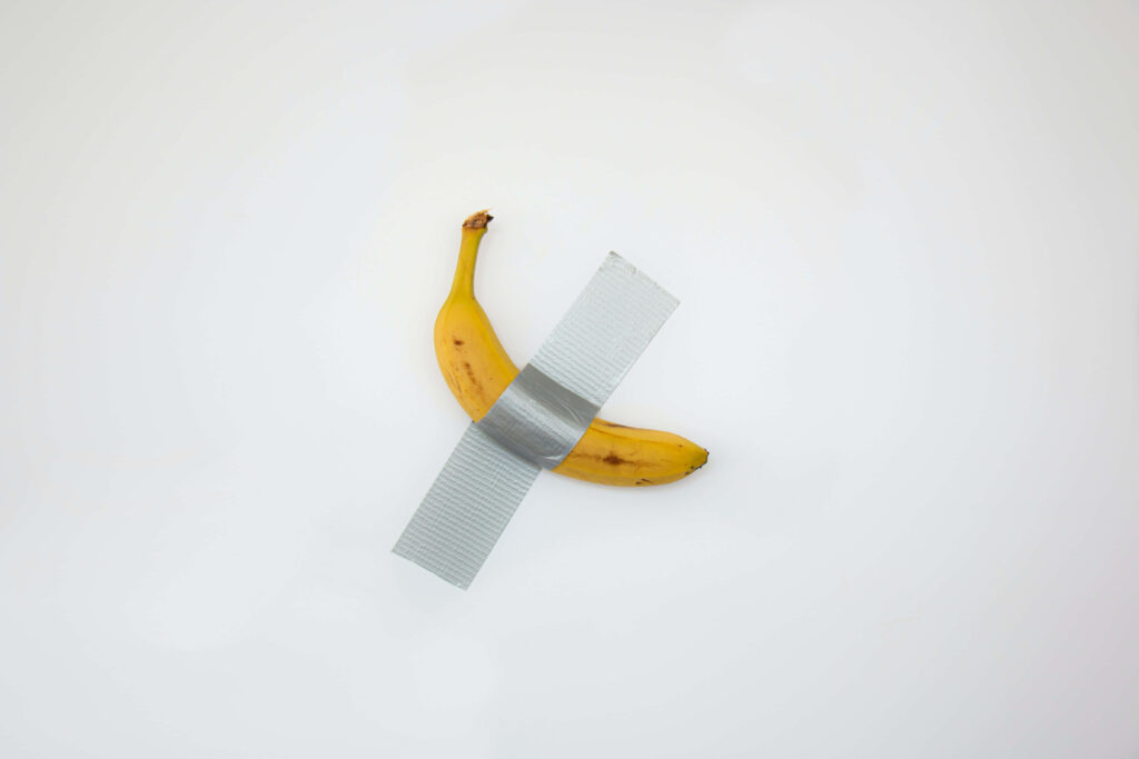 Ripe banana taped on white background minimalist artistic fruit wallpaper for modern decor