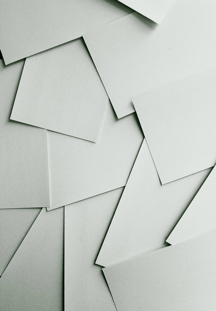 Minimalist wallpaper with overlapping sage green paper layers and soft shadows for calm desktop