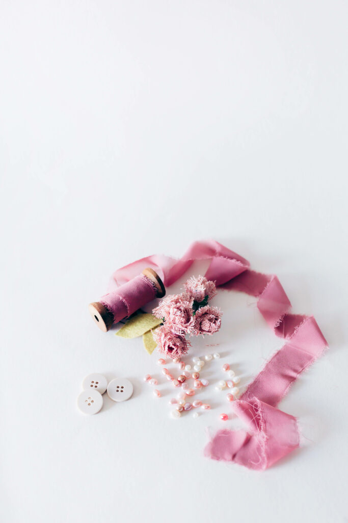 Minimalist Sewing Essentials: Pink Yarn, Flowers & Beads Wallpaper