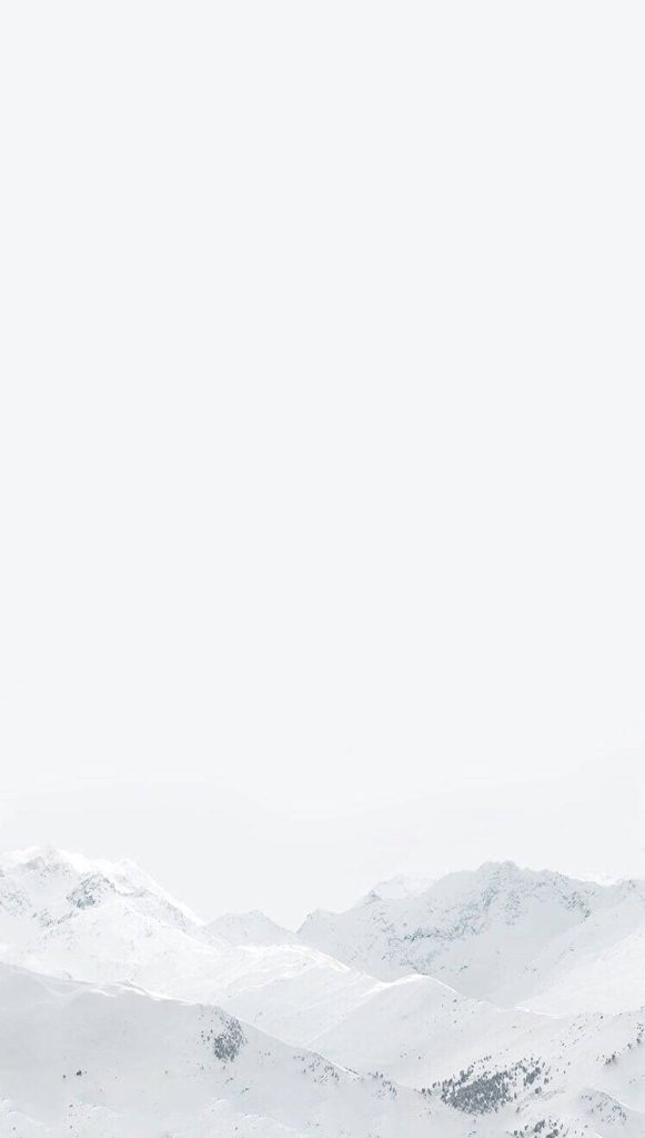 Minimalist high-key photo of snow-capped mountains with bright white sky peaceful winter wallpaper