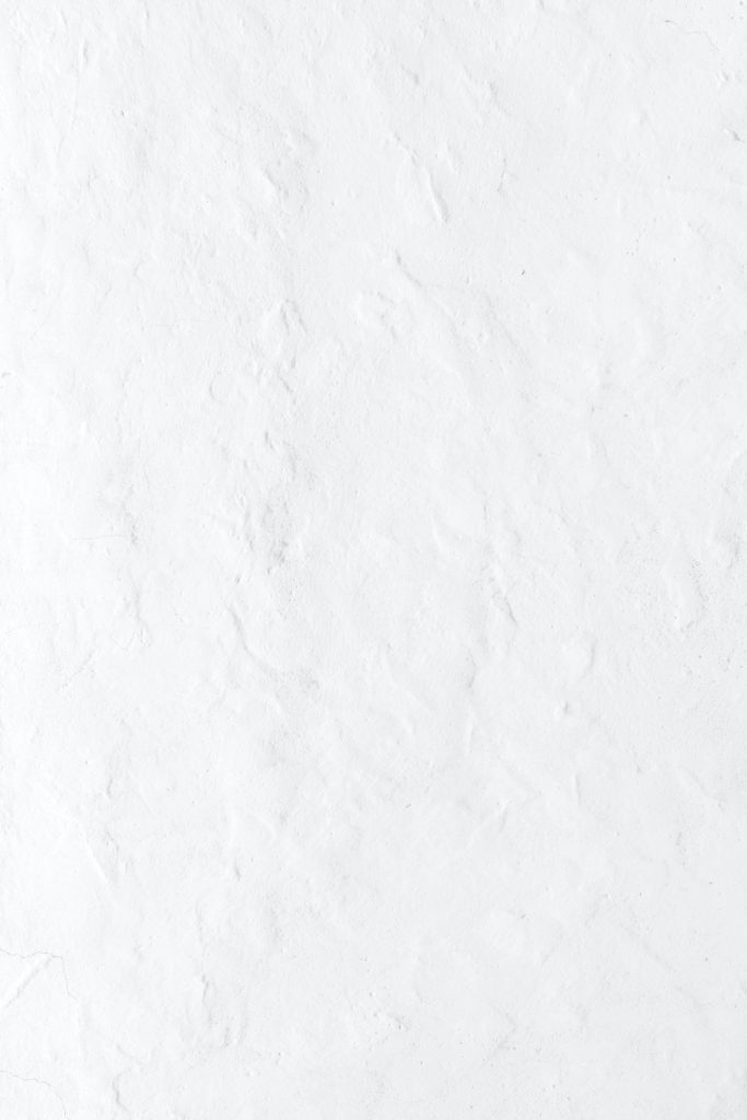 Solid white matte textured wallpaper mimicking plaster wall for a minimalist modern background