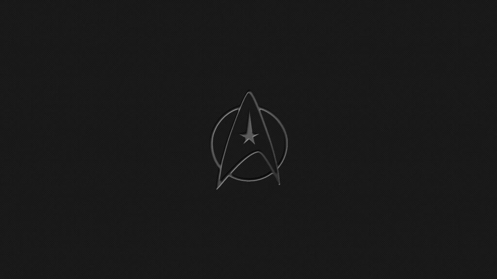 Minimalist Star Trek Wallpaper with Starfleet Insignia on Dark Background