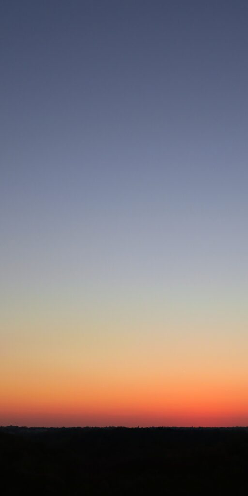 Minimalist sunset wallpaper with vibrant orange to twilight blue gradient for peaceful evenings