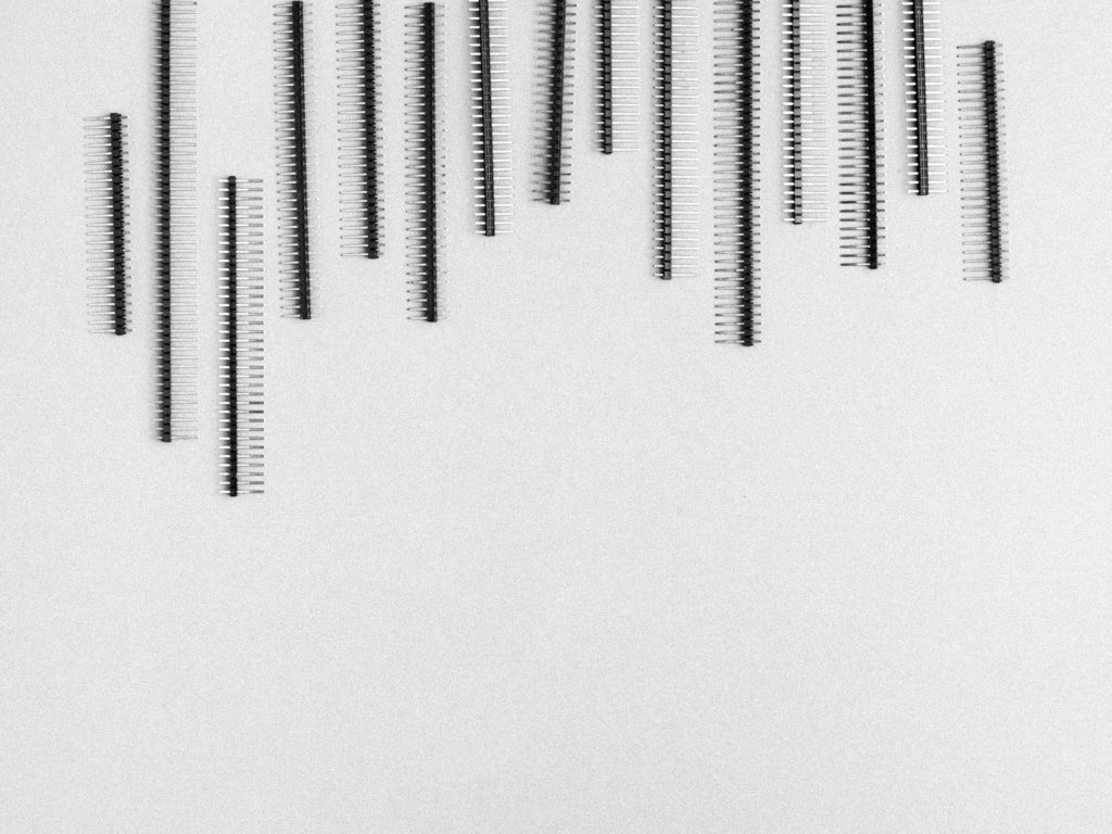 Minimalist black male pin headers vertical stripes on textured white background tech wallpaper