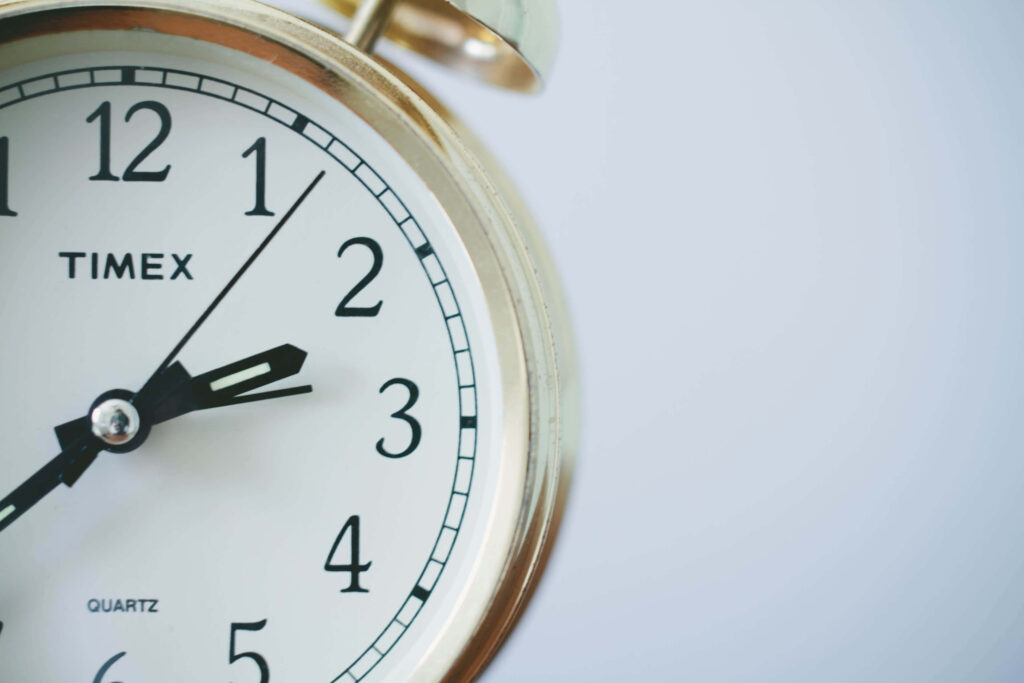 Close-up of classic Timex quartz clock right side minimalist wallpaper with bold black numbers