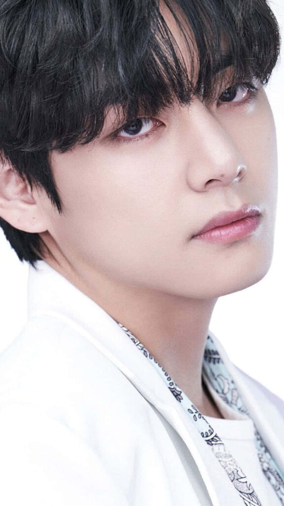 Close-up portrait of BTS V with soft expression on light background minimalist elegant wallpaper