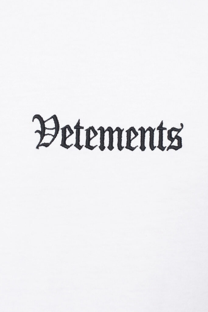 Bold black gothic Vetements embroidery on clean white minimalist stylish wallpaper background