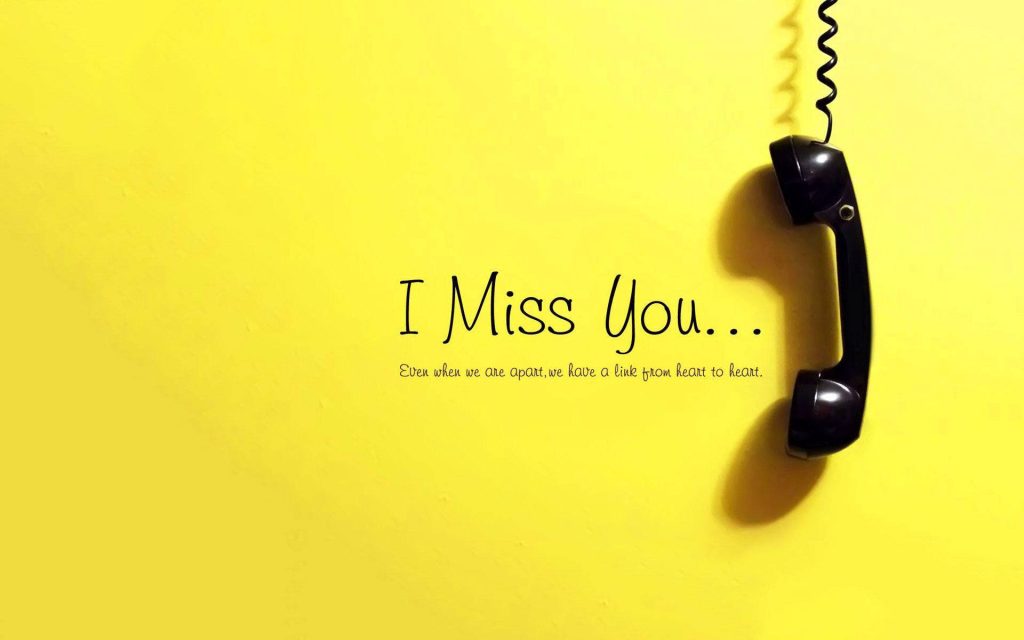Minimalist vintage black phone on yellow background with I Miss You text for long-distance love Wallpaper