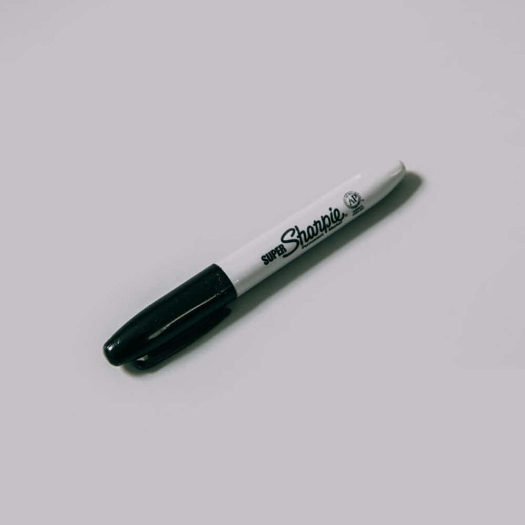 Classic Black Sharpie Marker on Light Gray Background Wallpaper