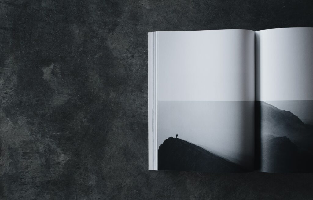 Minimalist Wallpaper: Open Book & Silhouette on Dark Mountain Ridge