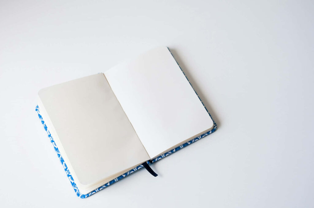 Minimalist Wallpaper: Open Notebook on White Background for Productivity