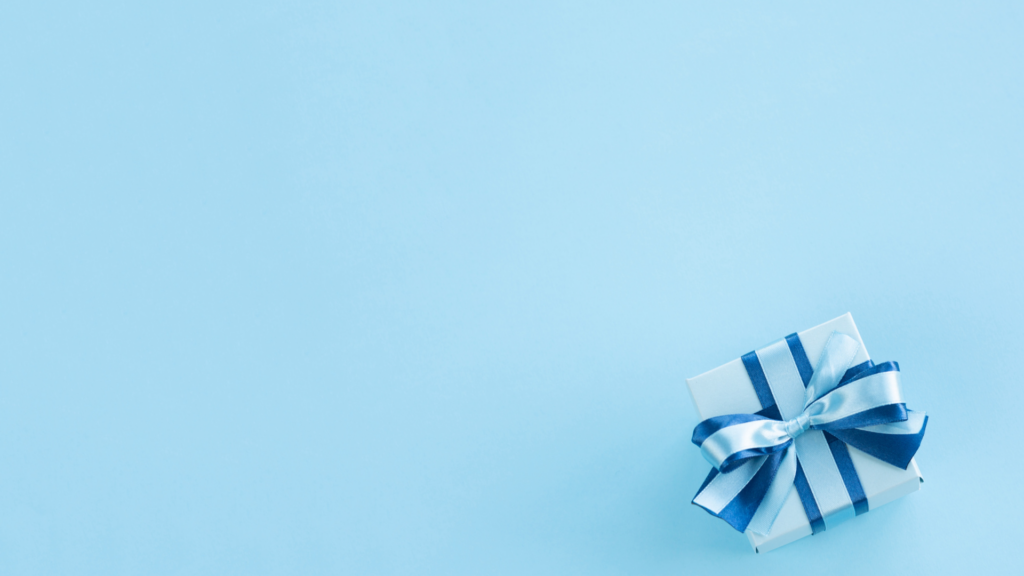 Minimalist Christmas Wallpaper: Wrapped Gift Box on Light Blue