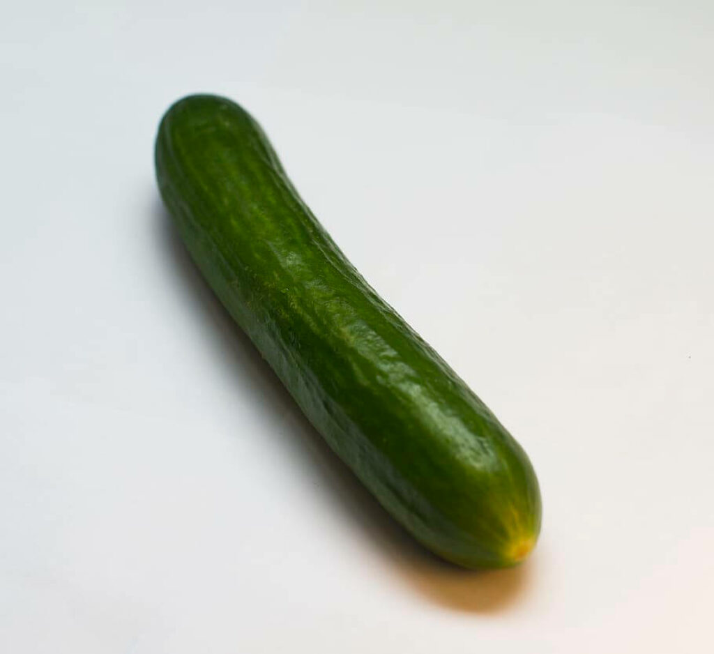 Minimalist Green Cucumber Wallpaper on Clean White Background