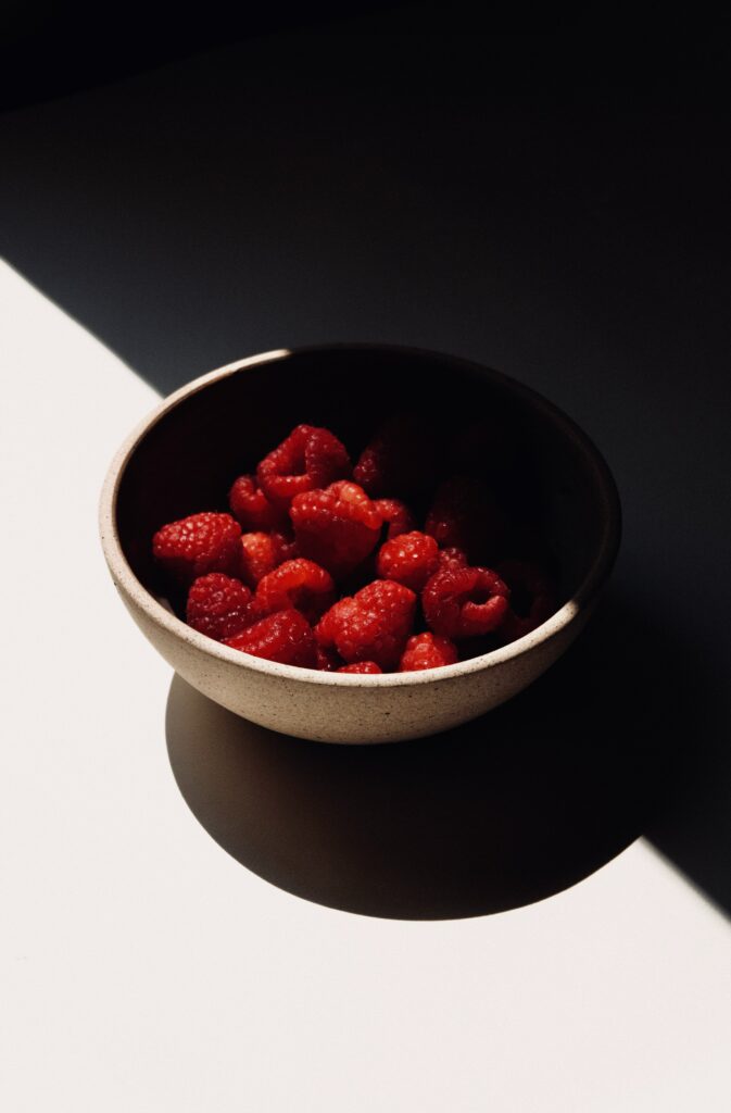 Minimalist Wallpaper: Fresh Raspberries in Light and Shadow
