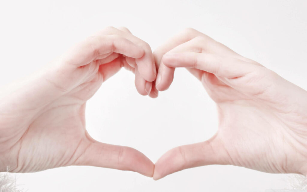 Minimalist Wallpaper: Hands Forming Heart Shape for Love & Unity