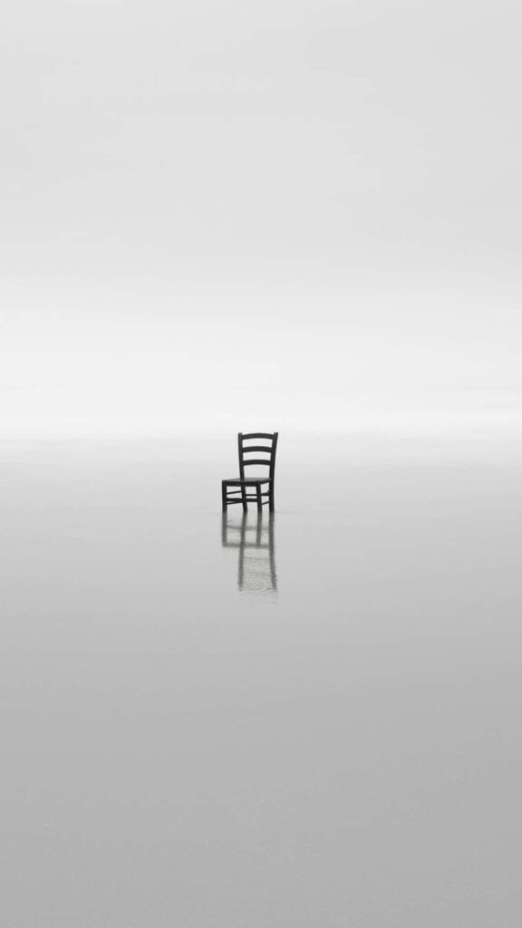 Minimalist Wooden Chair on Reflective Surface - Tranquil Wallpaper
