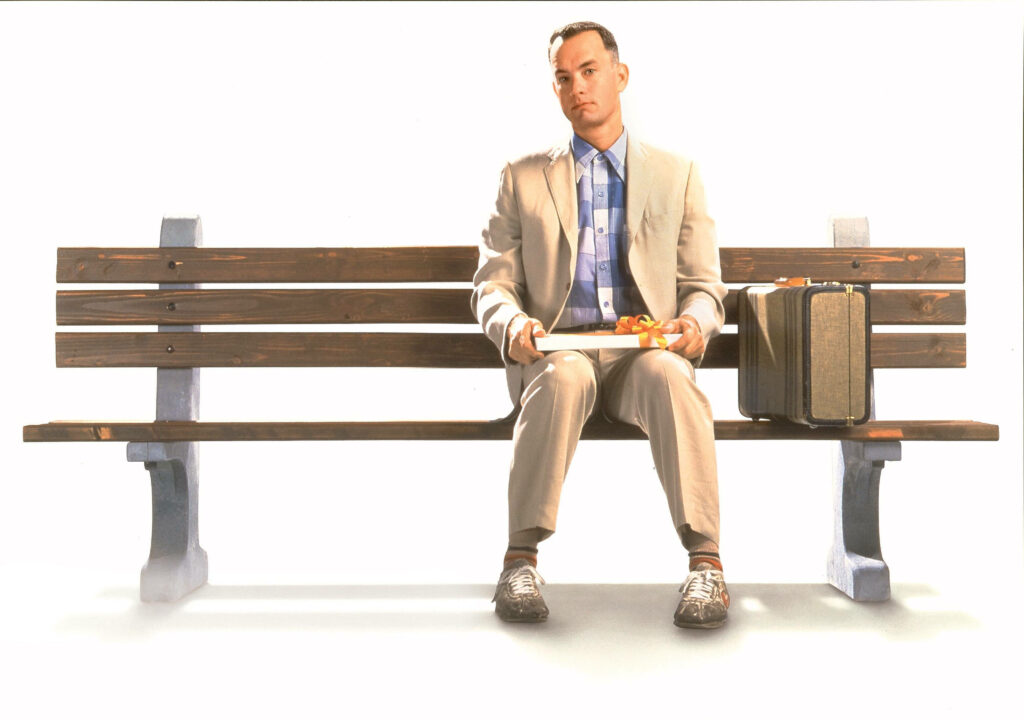Elegant Bench Moment: Man with Chocolates - Minimalistic Wallpaper