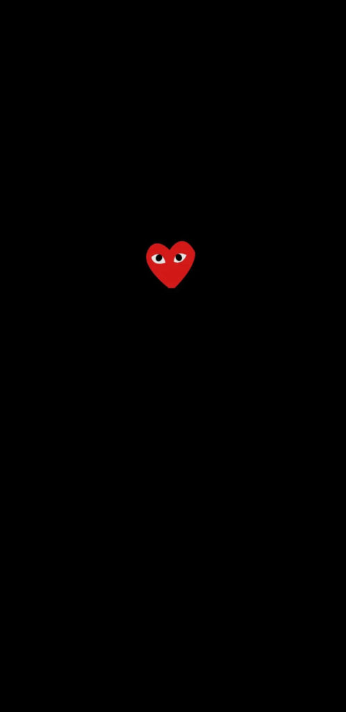 Minimalist Wallpaper: Tiny Red Comme Des Garçons Heart on Black