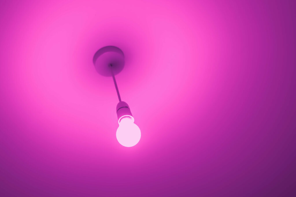 Minimalist Ceiling with Vibrant Pink Light Bulb Glow Background Wallpaper