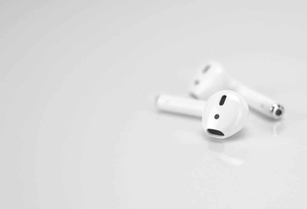 Minimalist wallpaper with white background and Apple AirPods 2nd Generation showcasing sleek design