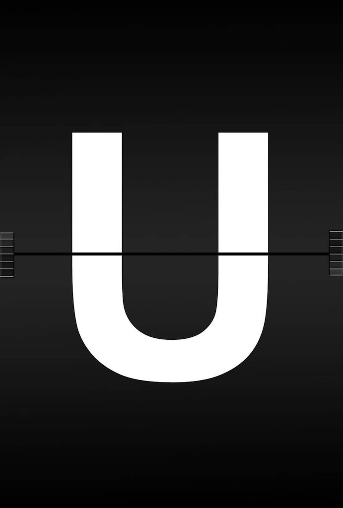 Minimalist White Letter U Wallpaper on black retro mechanical split-flap board background