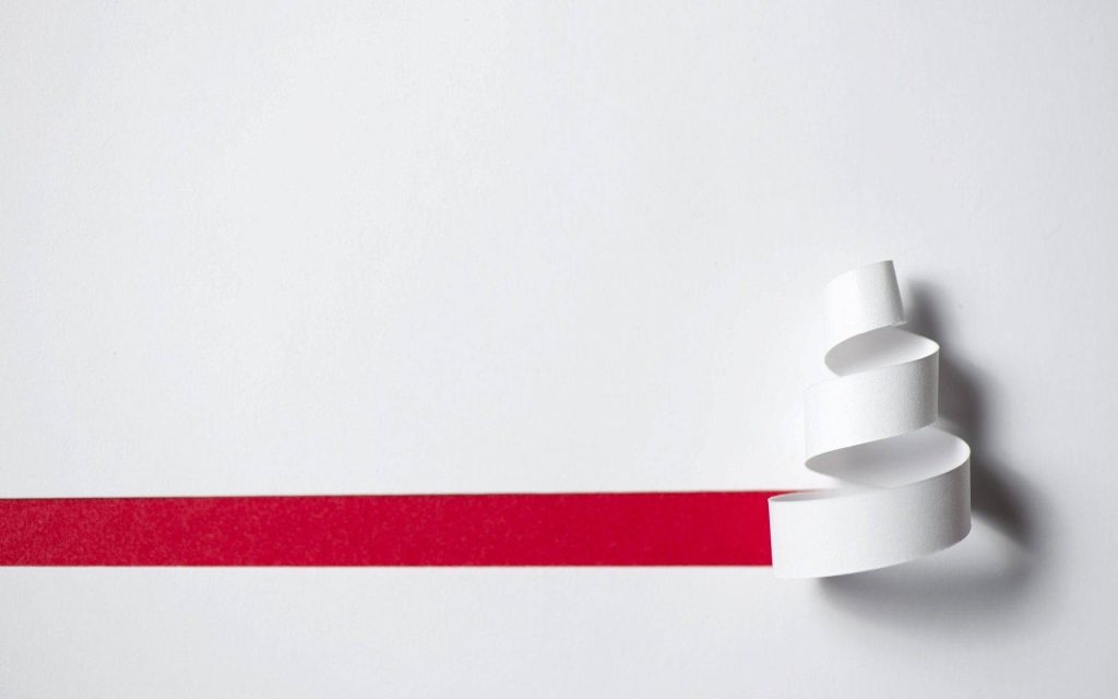 Minimalist wallpaper with white paper peeling to reveal vibrant red layer modern abstract design