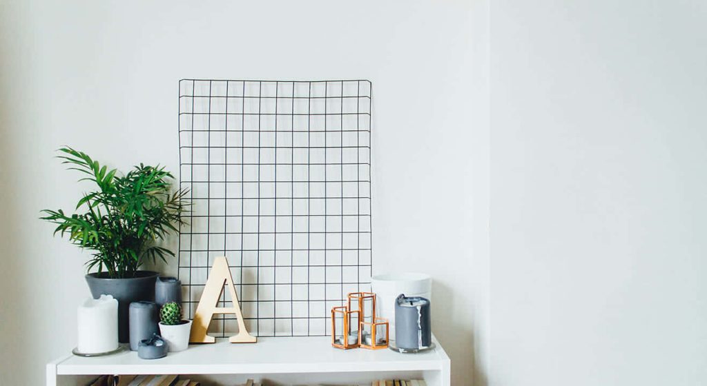 Minimalist virtual background with white shelf green plant wire grid wooden letter A copper decor Wallpaper