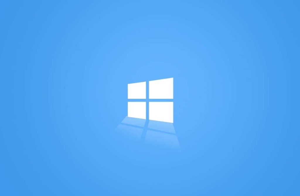Minimalist Windows logo wallpaper with white Microsoft symbol on soft blue gradient background