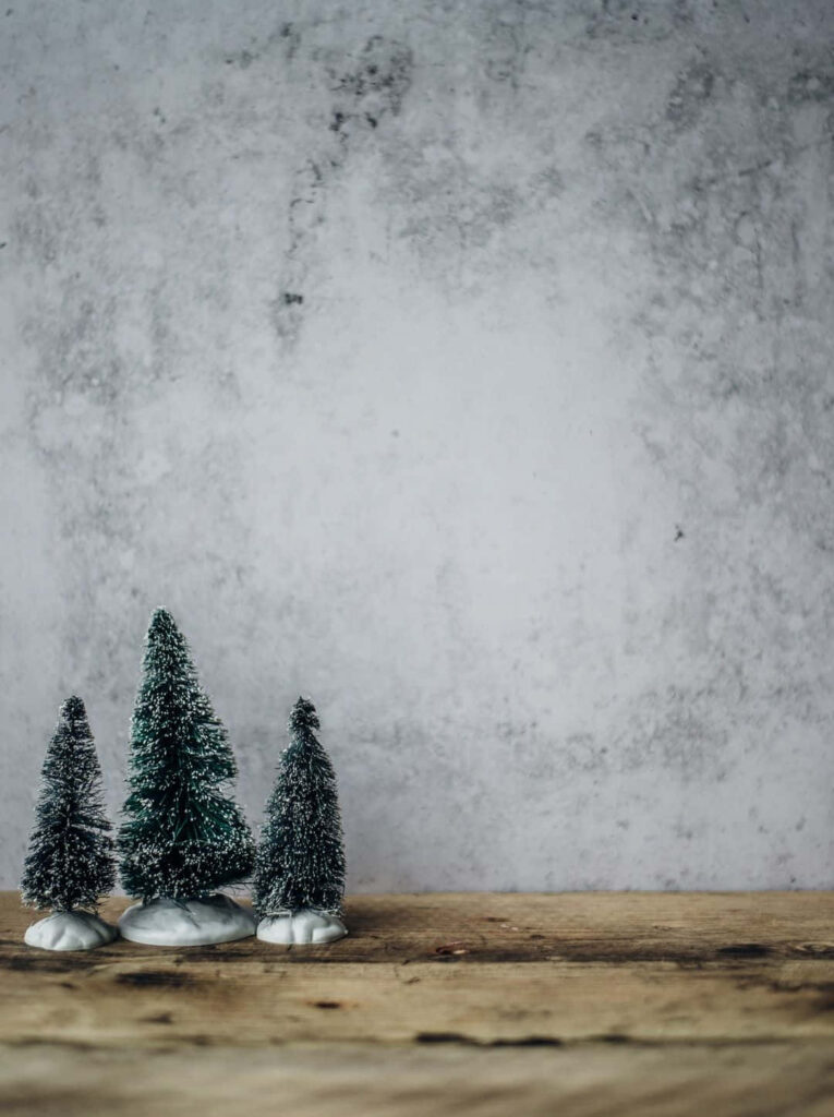 Minimalist Winter Wallpaper: Snowy Pines on Rustic Wood Background