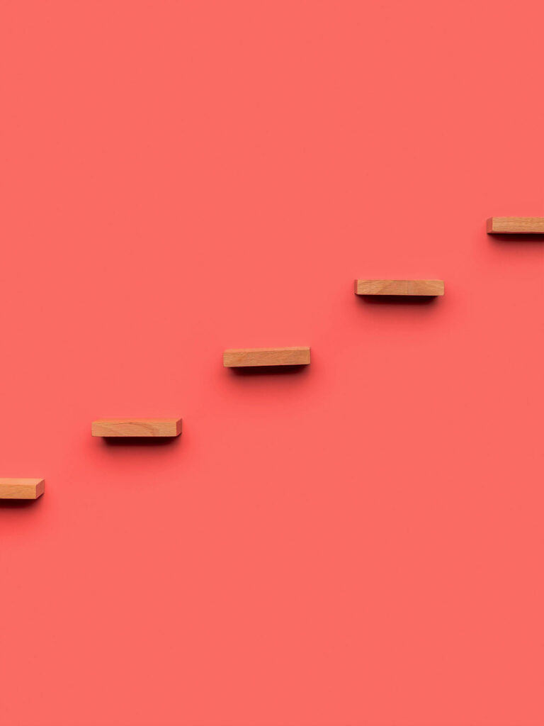 Minimalist Wooden Blocks Wallpaper on Pastel Red Background