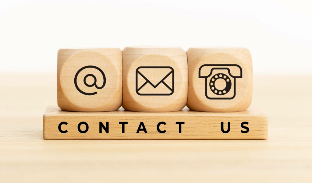 Minimalist wooden blocks with email phone icons and Contact Us text on smooth wood surface background Wallpaper