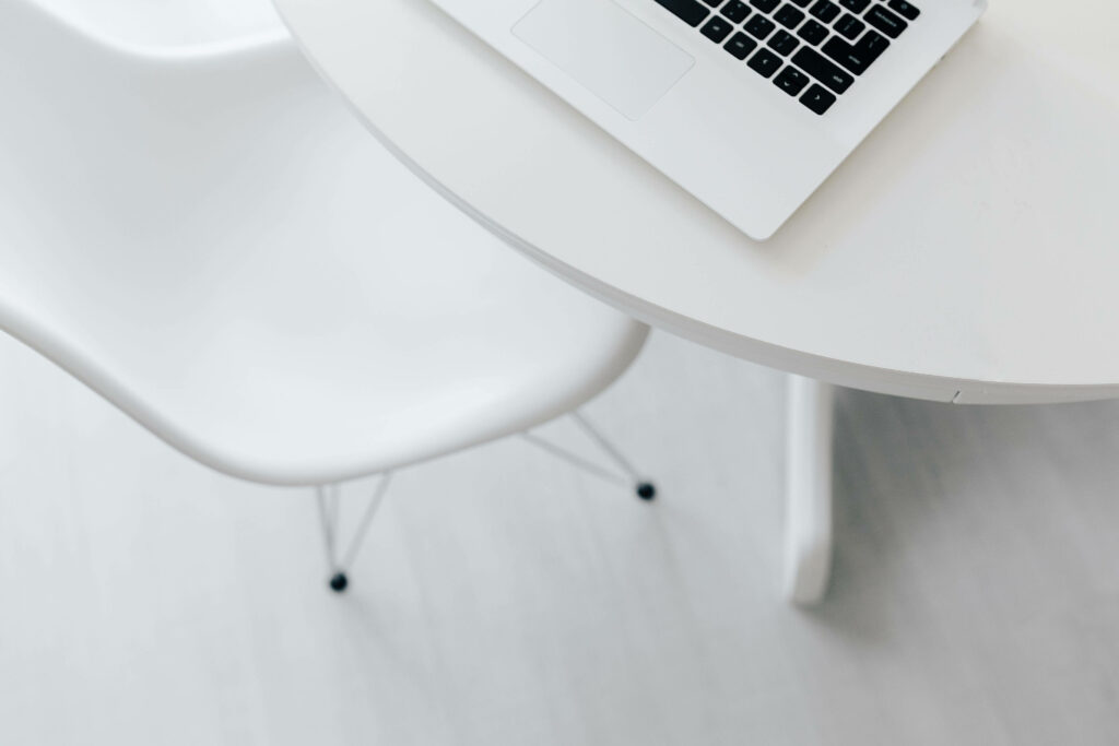 Minimalist Workspace Wallpaper: Sleek White Table & Eames Chair