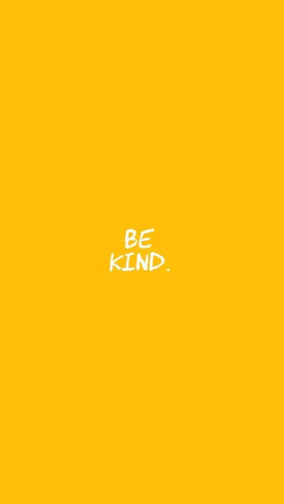 Minimalist yellow wallpaper with white handwritten be kind message bright cheerful background