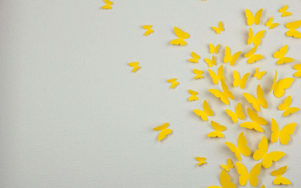 Minimalist Yellow Butterflies on Pastel Background - Serene Wallpaper