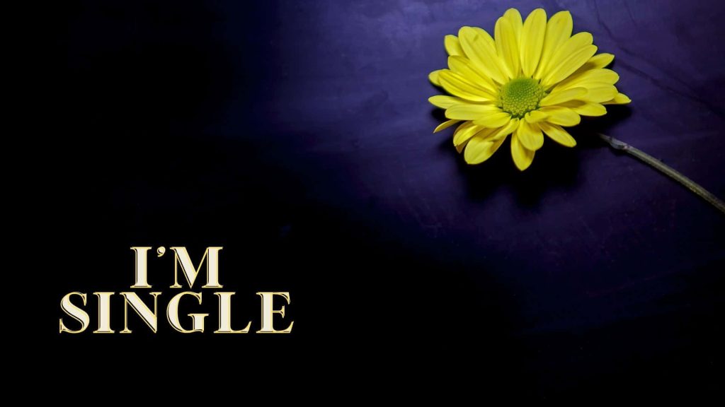 Minimalist wallpaper with vibrant yellow flower and bold Im Single text on dark purple background