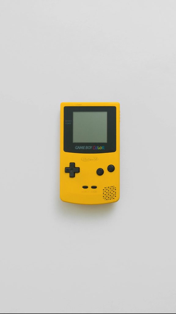 Minimalist yellow Nintendo Game Boy Color wallpaper retro gaming nostalgic desktop background