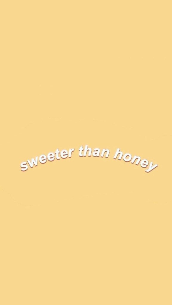 Minimalist yellow wallpaper with sweeter than honey white arched text for warm charming vibe