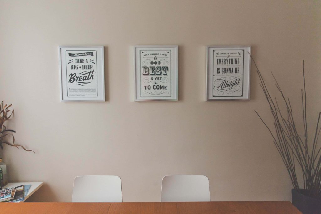 Minimalist Zoom background with neutral wall inspirational posters and white chairs for meetings Wallpaper