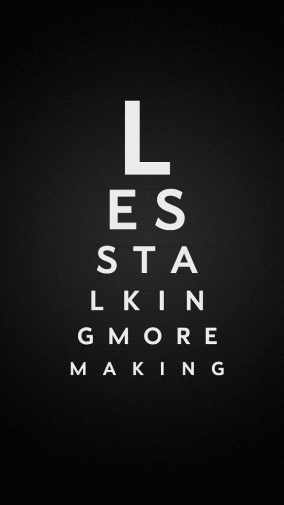 Minimalist iPhone wallpaper with eye chart typography spelling less talking more making on black background